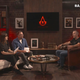 A screenshot of the Assassin's Creed showcase shows the hosts talking while an Assassin's Creed-themed Netflix logo is on a screen.